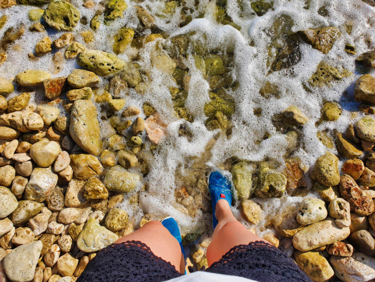 Elke wearing water shoes and standing in the Adriatic Sea