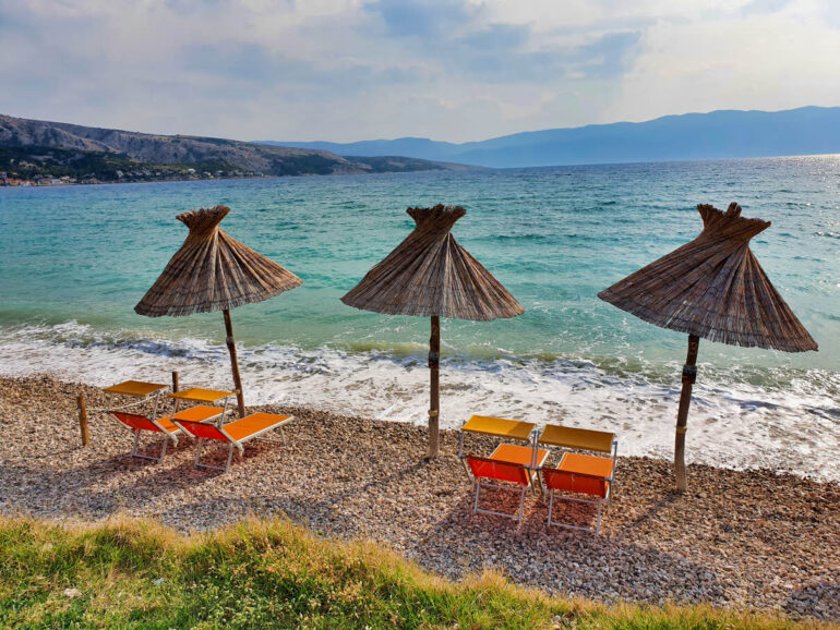 Umbrellas on the beach on Vela Plaža Baška beach